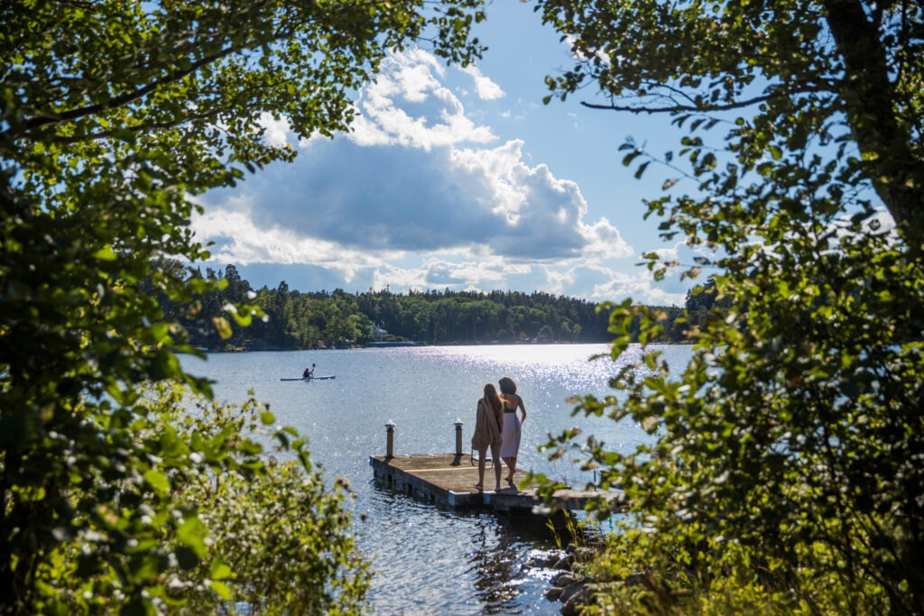 Vacations are a Swedish Tradition: Family members on a dock overlooking the archipelago.
